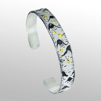 A silver bracelet with yellow and black design.