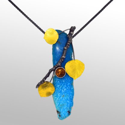 A blue bird with yellow and brown beads hanging from it's beak.