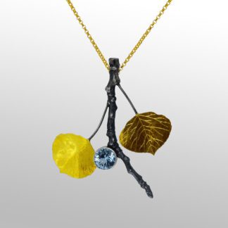 A yellow and black necklace with leaves on it