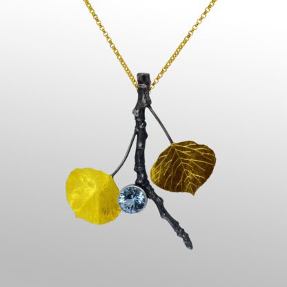A yellow and black necklace with leaves on it