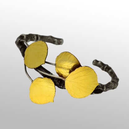 A yellow bracelet with four flowers on it.