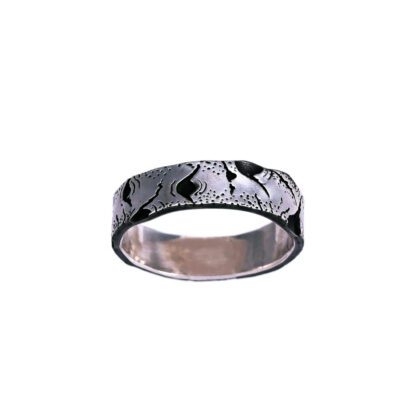 A silver ring with black paint on it.