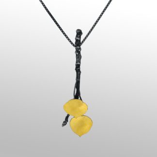 A yellow necklace with two hearts hanging from it.