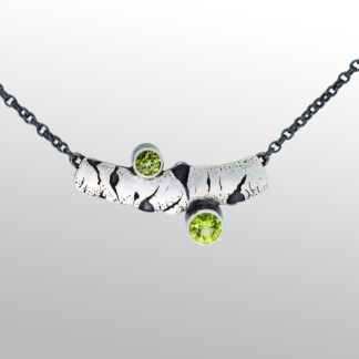 A necklace with two green stones on it.