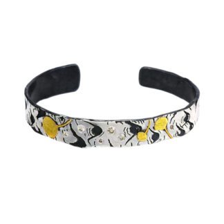 A white and black bracelet with yellow flowers