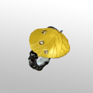 A yellow leaf with white and black diamonds on it.