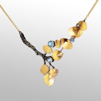 A necklace with gold leaves and blue stones.