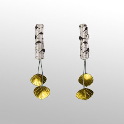 A pair of earrings with two gold discs hanging from them.