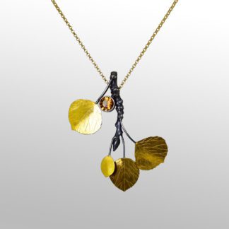A necklace with leaves hanging from it.