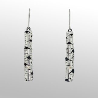 A pair of earrings with black and white designs.