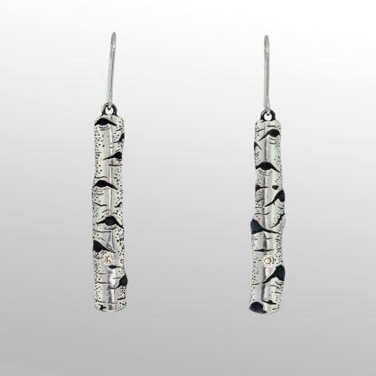 A pair of earrings with black and white designs.