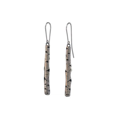 A pair of earrings with a long metal bar.