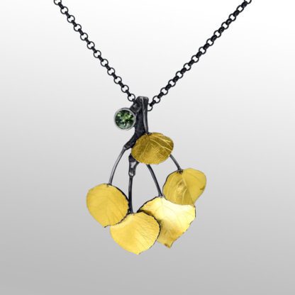 A necklace with gold leaves and green stone.