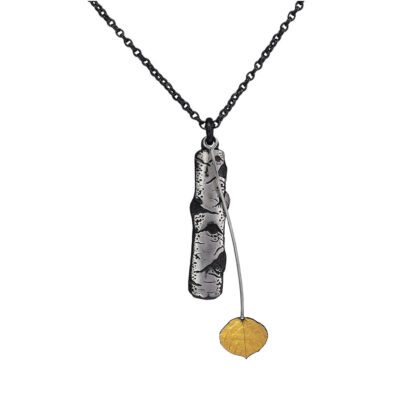 A necklace with a metal chain and a yellow pendant.