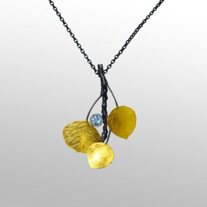 A necklace with three leaves and one blue stone.