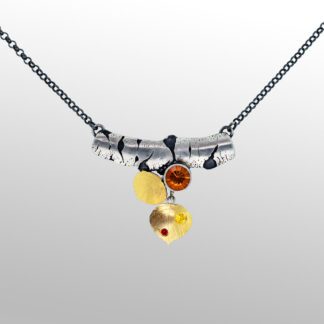 A necklace with a chain and two different colored stones.